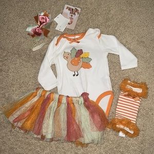 Baby girl turkey outfit with bow, leg warmers, and tutu skirt.